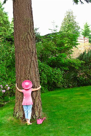 female tree huggers - Woman in festive pink hat hugging tree Stock Photo - Premium Royalty-Free, Code: 673-02216257