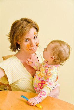 Frustrated mother feeding messy baby Stock Photo - Premium Royalty-Free, Code: 673-02216307