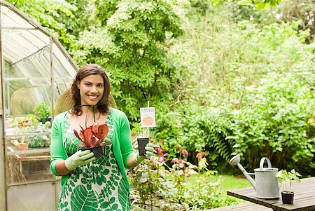 simsearch:673-02216253,k - Woman holding plants in garden Stock Photo - Premium Royalty-Free, Code: 673-02216407