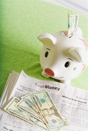 financial portfolio - Piggy bank, cash and financial section of newspaper Stock Photo - Premium Royalty-Free, Code: 673-02216488