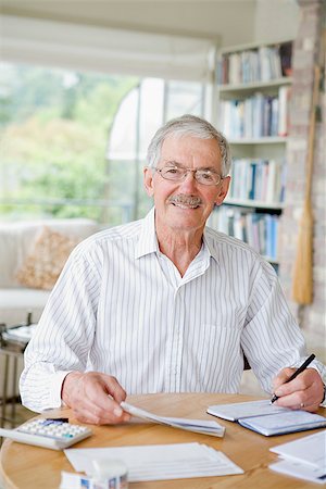 portrait of a elderly man - Man preparing home finance budget Stock Photo - Premium Royalty-Free, Code: 673-02386292