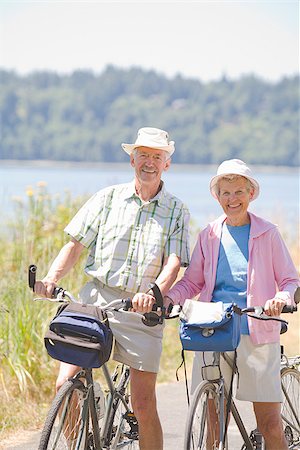 senior couple riding bicycles - Couple with their bicycles, Washington State, USA Stock Photo - Premium Royalty-Free, Code: 673-02386320