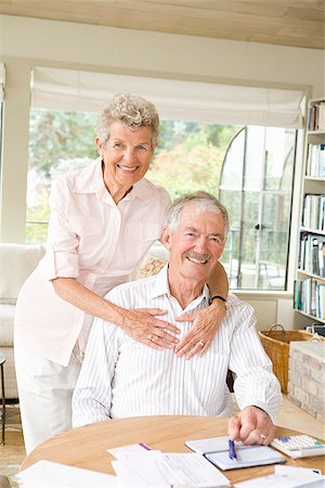 elderly couple on sofa - Portrait of a senior couple smiling Stock Photo - Premium Royalty-Free, Code: 673-02386347