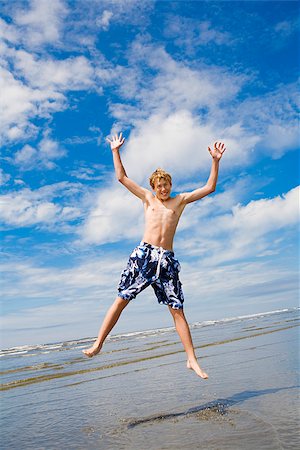 Boy jumping on the beach, Washington State, USA Stock Photo - Premium Royalty-Free, Code: 673-02386380