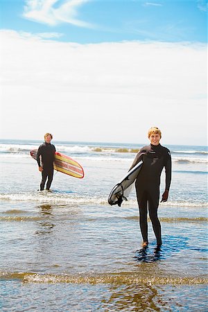 Surfers holding surfboards on the beach, Washington State, USA Stock Photo - Premium Royalty-Free, Code: 673-02386381