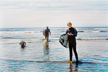 Surfers holding surfboards on the beach, Washington State, USA Stock Photo - Premium Royalty-Free, Code: 673-02386382