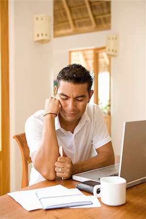 Man preparing home finance budget at home Stock Photo - Premium Royalty-Free, Code: 673-02386470