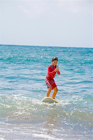 surfboard mobile - Girl surfing in the sea and using a mobile phone Stock Photo - Premium Royalty-Free, Code: 673-02386516