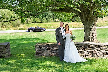 Newlywed couple standing in a park, East Meredith, New York State, USA Stock Photo - Premium Royalty-Free, Code: 673-02386647