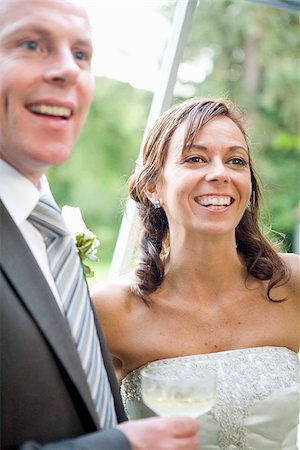 simsearch:673-02386650,k - Newlywed couple smiling and holding a champagne flute, East Meredith, New York State, USA Foto de stock - Sin royalties Premium, Código: 673-02386659