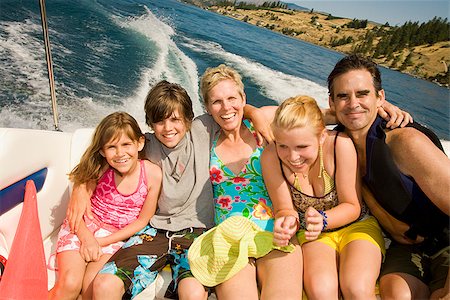 preteen one piece swimsuit - Family sitting in a motorboat Stock Photo - Premium Royalty-Free, Code: 673-02386702