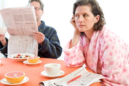 stress coffee - Worried woman with her husband at breakfast looking at newspaper Stock Photo - Premium Royalty-Free, Code: 673-02801284