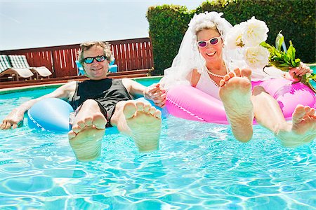 Bride and groom in swimming pool Stock Photo - Premium Royalty-Free, Code: 673-03005396