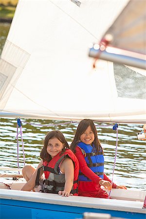 small boat - Two girls sailing small boat Stock Photo - Premium Royalty-Free, Code: 673-03005659
