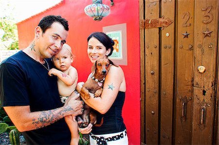 doors in mexico - tattoed mom and dad with baby Stock Photo - Premium Royalty-Free, Code: 673-03405717