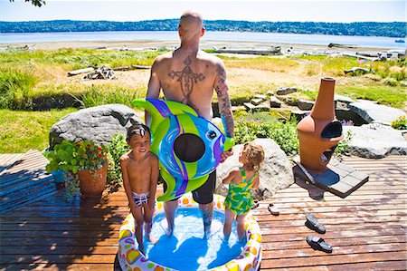 pacific girls photo - man with kids in wading pool near beach Stock Photo - Premium Royalty-Free, Code: 673-03405754