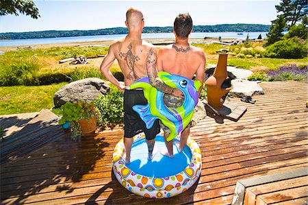 simsearch:673-03405759,k - tattoed men in wading pool near beach Stock Photo - Premium Royalty-Free, Code: 673-03405759