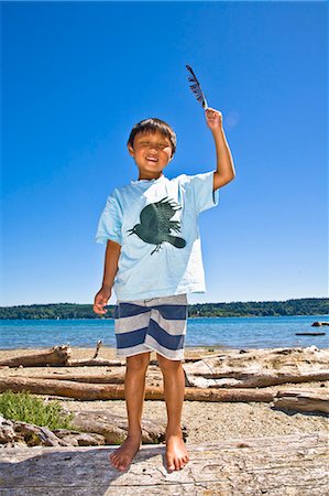 puget sound - boy on beach holding feather Stock Photo - Premium Royalty-Free, Code: 673-03405763