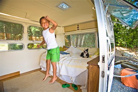 people jumping into bed - Boy and dog on bed in camper Stock Photo - Premium Royalty-Free, Code: 673-03405774