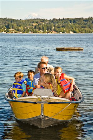 men and young children on motorboat ride Stock Photo - Premium Royalty-Free, Code: 673-03405799