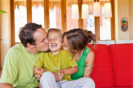 family cuddling on sofa Stock Photo - Premium Royalty-Free, Code: 673-03623259