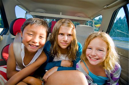 friends inside the car - children making faces in car Stock Photo - Premium Royalty-Free, Code: 673-03826307