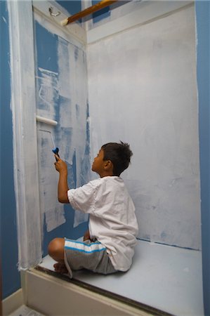 boy painting wall in closet Stock Photo - Premium Royalty-Free, Code: 673-03826313