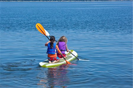 girls on paddle board in lake Stock Photo - Premium Royalty-Free, Code: 673-03826325