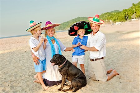 family on beach with dog Stock Photo - Premium Royalty-Free, Code: 673-03826423