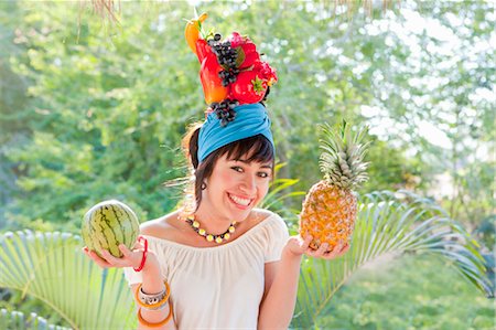 single pineapple - young woman wearing fruit hat Stock Photo - Premium Royalty-Free, Code: 673-03826452