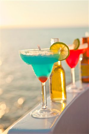 fruits and water - row of cocktails on boat rail Stock Photo - Premium Royalty-Free, Code: 673-03826491