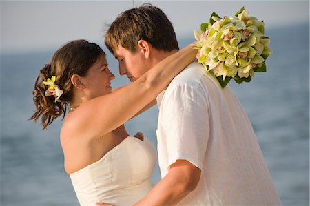 bridal couple hugging on beach Stock Photo - Premium Royalty-Free, Code: 673-03826530