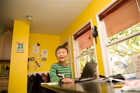 simsearch:673-06025502,k - boy with laptop at kitchen table Stock Photo - Premium Royalty-Free, Code: 673-03826551