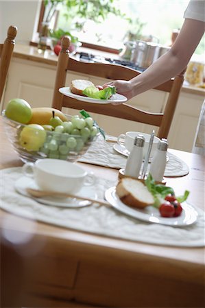 Young woman setting table Stock Photo - Premium Royalty-Free, Code: 685-02937139