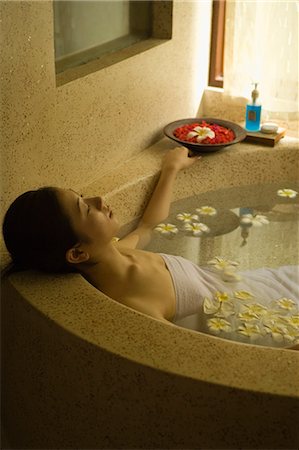 simsearch:685-02937230,k - Young woman taking bath with flower petals Stock Photo - Premium Royalty-Free, Code: 685-02937237