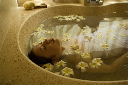 simsearch:685-02937230,k - Young woman taking bath with flower petals Stock Photo - Premium Royalty-Free, Code: 685-02937239