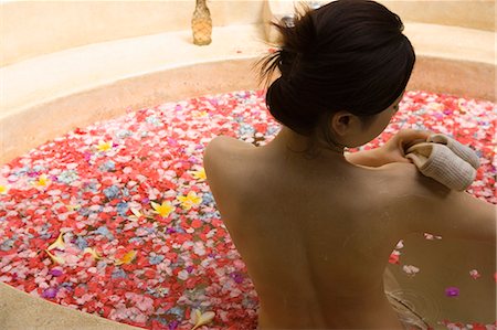 simsearch:685-02937230,k - Young woman taking bath with flower petals Stock Photo - Premium Royalty-Free, Code: 685-02937232