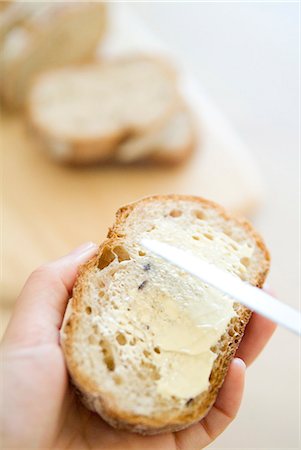 Spreading butter on bread Stock Photo - Premium Royalty-Free, Code: 685-02937357