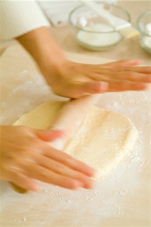 Woman rolling dough, blurred motion Stock Photo - Premium Royalty-Free, Code: 685-02937360