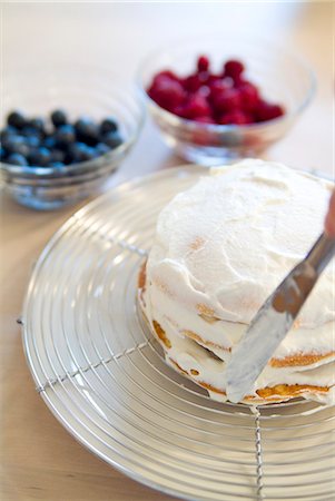 Putting whipped cream on pancake Stock Photo - Premium Royalty-Free, Code: 685-02937376