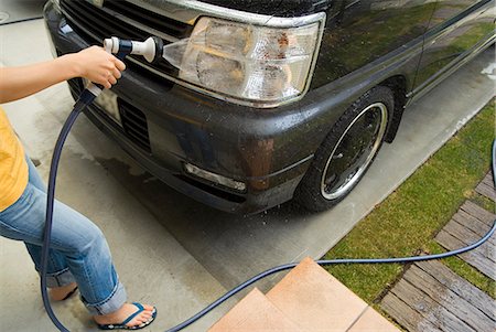 A woman washing a car Stock Photo - Premium Royalty-Free, Code: 685-02938022