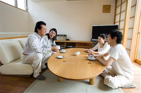 Family relaxing in living room Stock Photo - Premium Royalty-Free, Code: 685-02938153