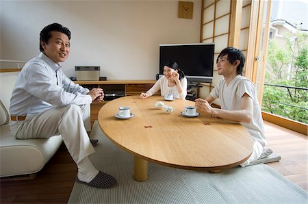 Family relaxing in living room Stock Photo - Premium Royalty-Free, Code: 685-02938163