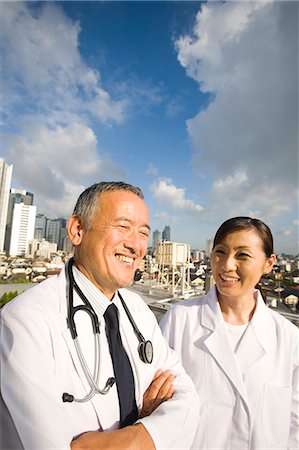 simsearch:685-02941550,k - Doctors talking on roof Stock Photo - Premium Royalty-Free, Code: 685-02938386