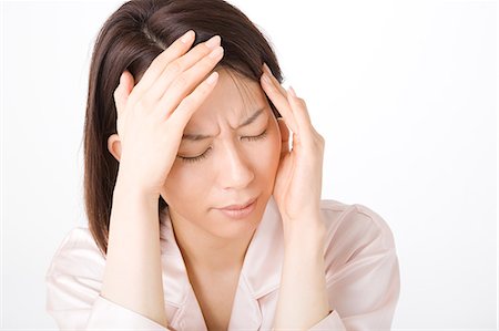 simsearch:685-02938526,k - A woman suffering from headache Stock Photo - Premium Royalty-Free, Code: 685-02938522