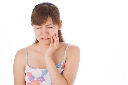 simsearch:685-02938515,k - A young woman suffering from toothache Stock Photo - Premium Royalty-Free, Code: 685-02938535