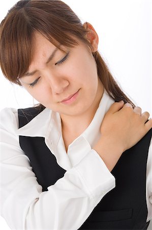 simsearch:685-02938526,k - A young woman massaging shoulder Stock Photo - Premium Royalty-Free, Code: 685-02938548