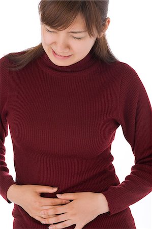simsearch:685-02938515,k - A young woman suffering from abdominal pain Stock Photo - Premium Royalty-Free, Code: 685-02938541