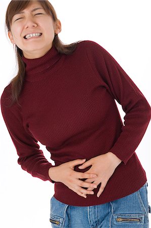simsearch:685-02938515,k - A young woman suffering from abdominal pain Stock Photo - Premium Royalty-Free, Code: 685-02938542