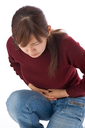 simsearch:685-02938515,k - A young woman suffering from abdominal pain Stock Photo - Premium Royalty-Free, Code: 685-02938543